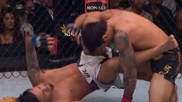 Alexandre Pantoja takes Brandon Royval down in their UFC 296 title fight.